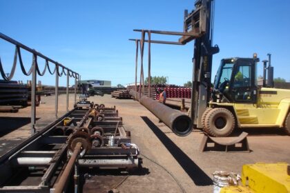 bobcat transporting pipe